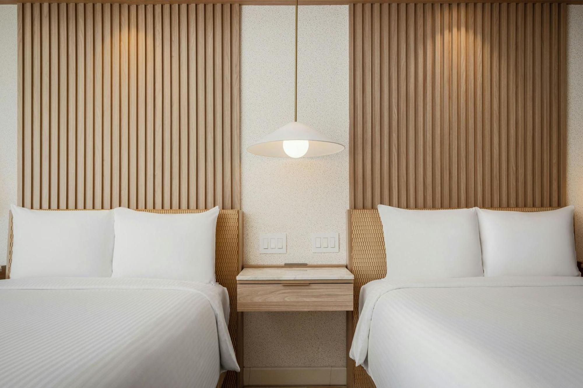 Guest room 2 double beds balcony partial ocean view
